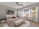 Bright main bedroom features many windows, desert views, ceiling fan, and neutral toned decor at 10775 E Peralta Canyon Dr, Gold Canyon, AZ 85118