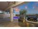 Outdoor kitchen featuring a smoker, stainless steel grill, and view of desert landscape at 10775 E Peralta Canyon Dr, Gold Canyon, AZ 85118