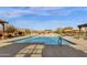 Community pool features comfortable lounge chairs and shaded pergola with mountain views in the distance at 10775 E Peralta Canyon Dr, Gold Canyon, AZ 85118