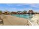 Large pool with shaded lounge chairs, pergolas, and desert landscaping at 10775 E Peralta Canyon Dr, Gold Canyon, AZ 85118