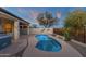 A private backyard oasis featuring a pool, desert landscaping, and artistic lizard wall hangings at 10775 E Peralta Canyon Dr, Gold Canyon, AZ 85118