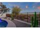 Desert landscaping surrounds the pool, enclosed by a fence overlooking the natural desert landscape at 10775 E Peralta Canyon Dr, Gold Canyon, AZ 85118