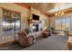 Inviting sitting area with stone fireplace and beautiful outdoor view at 10775 E Peralta Canyon Dr, Gold Canyon, AZ 85118