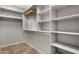 Walk-in closet with built-in shelving and tile flooring at 10775 E Peralta Canyon Dr, Gold Canyon, AZ 85118
