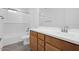 Bathroom featuring a bath tub, shower, and vanity with wood cabinets at 10860 E Tiburon Ave, Mesa, AZ 85212