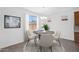 Stylish dining area with modern light fixture, neutral decor, and elegant table setting at 10860 E Tiburon Ave, Mesa, AZ 85212