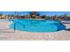 A pristine community pool featuring sparkling blue water and plenty of lounge chairs for residents to relax at 10860 E Tiburon Ave, Mesa, AZ 85212