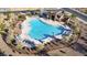 Aerial view of a community pool with lounge chairs, shade structures, and well-maintained landscaping at 10905 E Texas Ave, Mesa, AZ 85212