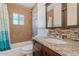 Updated bathroom features granite countertop, tiled shower and mosaic tile backsplash at 1117 W Glenrosa Ave, Phoenix, AZ 85013