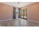 Bedroom features light pink walls, wood-framed glass doors, and tile floors at 1117 W Glenrosa Ave, Phoenix, AZ 85013