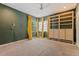 Bedroom boasts green walls, yellow drapes, and custom wooden shelving at 1117 W Glenrosa Ave, Phoenix, AZ 85013
