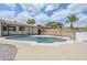 Enjoy the backyard oasis featuring a pool with desert landscaping and palm trees at 11631 N 30Th St, Phoenix, AZ 85028