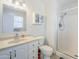 This bathroom has a shower, toilet, sink, cabinet, and a mirror on the wall at 11631 N 30Th St, Phoenix, AZ 85028