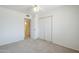 A cozy bedroom features soft carpet, a ceiling fan, and ample closet space, creating a comfortable and inviting atmosphere at 11631 N 30Th St, Phoenix, AZ 85028