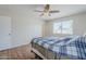 A comfortable bedroom features wood floors, a ceiling fan, and lots of natural light at 11631 N 30Th St, Phoenix, AZ 85028