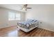 A well-lit bedroom includes a window, wood floors, and a cozy bed for a comfortable living space at 11631 N 30Th St, Phoenix, AZ 85028