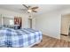 This bedroom features wood-look floors, a large window, and a door to a bathroom at 11631 N 30Th St, Phoenix, AZ 85028