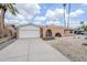 Single-story home featuring a brick facade, desert landscaping, arched entry, and an attached garage at 11631 N 30Th St, Phoenix, AZ 85028