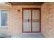 Inviting front porch with brick accent, steel security doors, and a window bringing in natural light at 11631 N 30Th St, Phoenix, AZ 85028