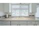Well-lit kitchen with a view of the pool, featuring all-white cabinetry and countertops at 11631 N 30Th St, Phoenix, AZ 85028