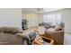 Comfortable living room with neutral walls, wood flooring, ceiling fan, and large windows for natural light at 11631 N 30Th St, Phoenix, AZ 85028
