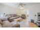 Spacious living room with comfortable seating, wood floors, a ceiling fan, and neutral decor at 11631 N 30Th St, Phoenix, AZ 85028