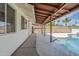 Covered patio area with dark wood beams and a view of the pool at 11631 N 30Th St, Phoenix, AZ 85028