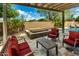Inviting covered patio with hot tub, comfortable seating, and lush landscaping perfect for outdoor entertaining and relaxation at 1268 N Pine St, Gilbert, AZ 85233