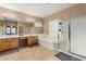 A spacious bathroom featuring double sinks, a soaking tub, and a glass-enclosed shower at 1268 N Pine St, Gilbert, AZ 85233