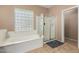 Beautiful bathroom featuring a tub with glass block window and glass door shower stall at 1268 N Pine St, Gilbert, AZ 85233