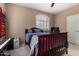 Relaxing bedroom featuring a ceiling fan, bed, and window with shutters at 1268 N Pine St, Gilbert, AZ 85233