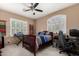 Comfortable bedroom with computer desk, shutters, and ceiling fan at 1268 N Pine St, Gilbert, AZ 85233