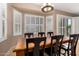 Bright dining room featuring a dark wood table, seating for six and plantation shutters at 1268 N Pine St, Gilbert, AZ 85233