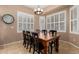 Bright dining room featuring a dark wood table, seating for eight and plantation shutters at 1268 N Pine St, Gilbert, AZ 85233