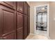 Hallway with pantry cabinets leading to workout room and gym equipment at 1268 N Pine St, Gilbert, AZ 85233