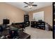 Spacious home office with a dark desk, ceiling fan and built in shelving at 1268 N Pine St, Gilbert, AZ 85233