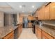 Bright kitchen with stainless steel appliances, tile floors, and granite countertops at 1268 N Pine St, Gilbert, AZ 85233