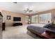 Spacious main bedroom featuring plush carpet, fan, and plantation shutters at 1268 N Pine St, Gilbert, AZ 85233
