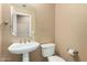 Powder room featuring pedestal sink, toilet and neutral paint at 1268 N Pine St, Gilbert, AZ 85233
