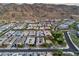 A wide aerial captures a neighborhood of modern homes with desert landscaping against a backdrop of mountains at 1337 E Paseo Way, Phoenix, AZ 85042