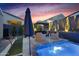 Stylish backyard oasis with a covered lounge area, poolside seating, and desert-inspired landscaping at 1337 E Paseo Way, Phoenix, AZ 85042
