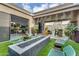 Inviting backyard featuring a fire pit, seating, and outdoor bar for seamless indoor-outdoor living at 1337 E Paseo Way, Phoenix, AZ 85042