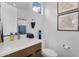 Bright bathroom with a modern vanity, framed art, and a window for natural light, offering a clean and stylish space at 1337 E Paseo Way, Phoenix, AZ 85042