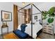 Stylish bedroom features a four-poster bed, accent furniture, and modern decor, creating a cozy and inviting atmosphere at 1337 E Paseo Way, Phoenix, AZ 85042