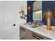 Stylish butler's pantry with quartz countertops, ample storage, and an elegant color scheme at 1337 E Paseo Way, Phoenix, AZ 85042