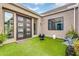Private courtyard featuring a modern front door, artificial turf, playful decor, and stylish seating for outdoor enjoyment at 1337 E Paseo Way, Phoenix, AZ 85042