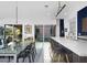 Dining room featuring a glass table, modern lighting, and access to the outdoor patio area at 1337 E Paseo Way, Phoenix, AZ 85042