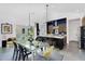 Open concept dining area adjacent to the kitchen with modern fixtures and a glass table set for six at 1337 E Paseo Way, Phoenix, AZ 85042