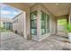 Inviting exterior of a modern home featuring a covered patio with stylish windows and stone pavers at 1337 E Paseo Way, Phoenix, AZ 85042