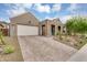 Eye-catching exterior view featuring a paver driveway, modern design, and desert landscaping at 1337 E Paseo Way, Phoenix, AZ 85042